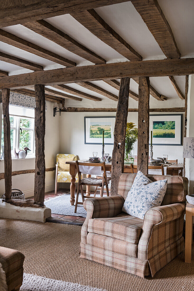 Rustic living room with wooden beams and watercolours on the wall