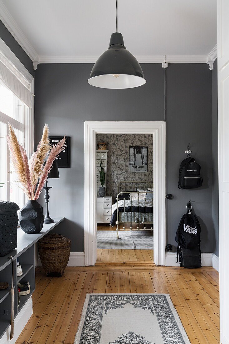 Hallway with grey walls and wooden floorboards
