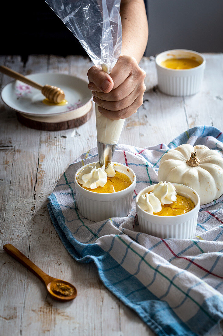 Small pumpkin cheesecakes with whipped cream