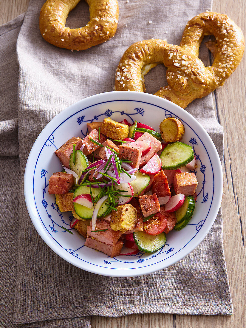 Salad with meatloaf and pretzels