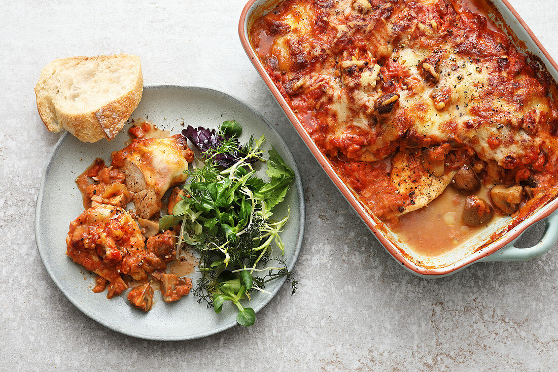 Oven-baked chicken steaks with mushrooms, tomatoes and mozzarella