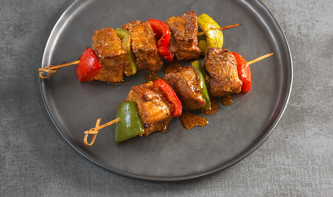 Spicy pork skewers with peppers and Mexican spices
