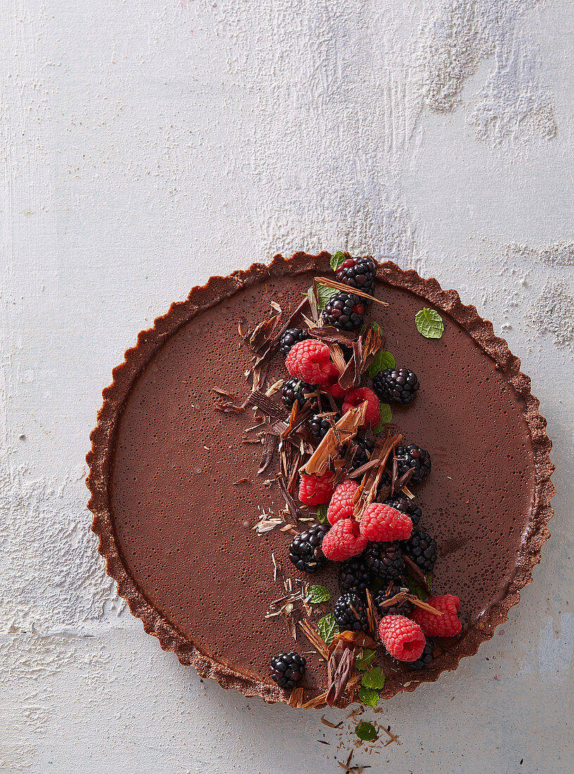 Unbaked chocolate cake with wild berries