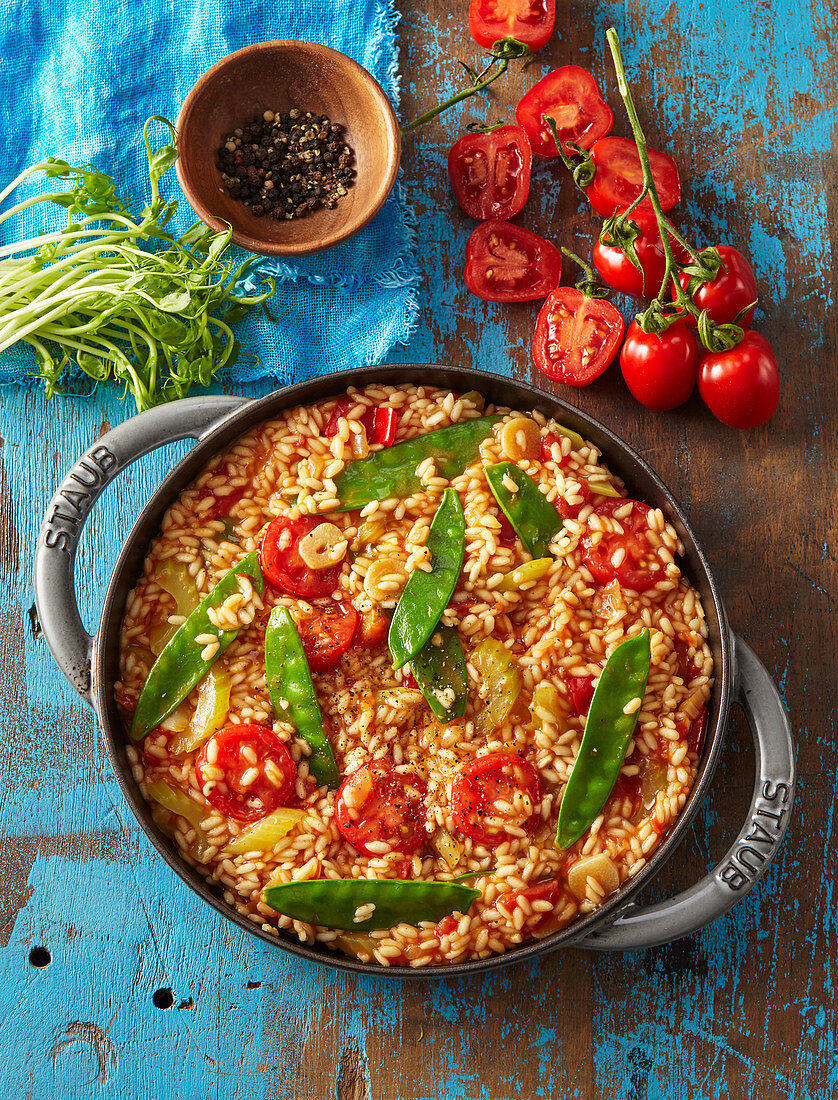 Vegetarian tomato paella with mangetout