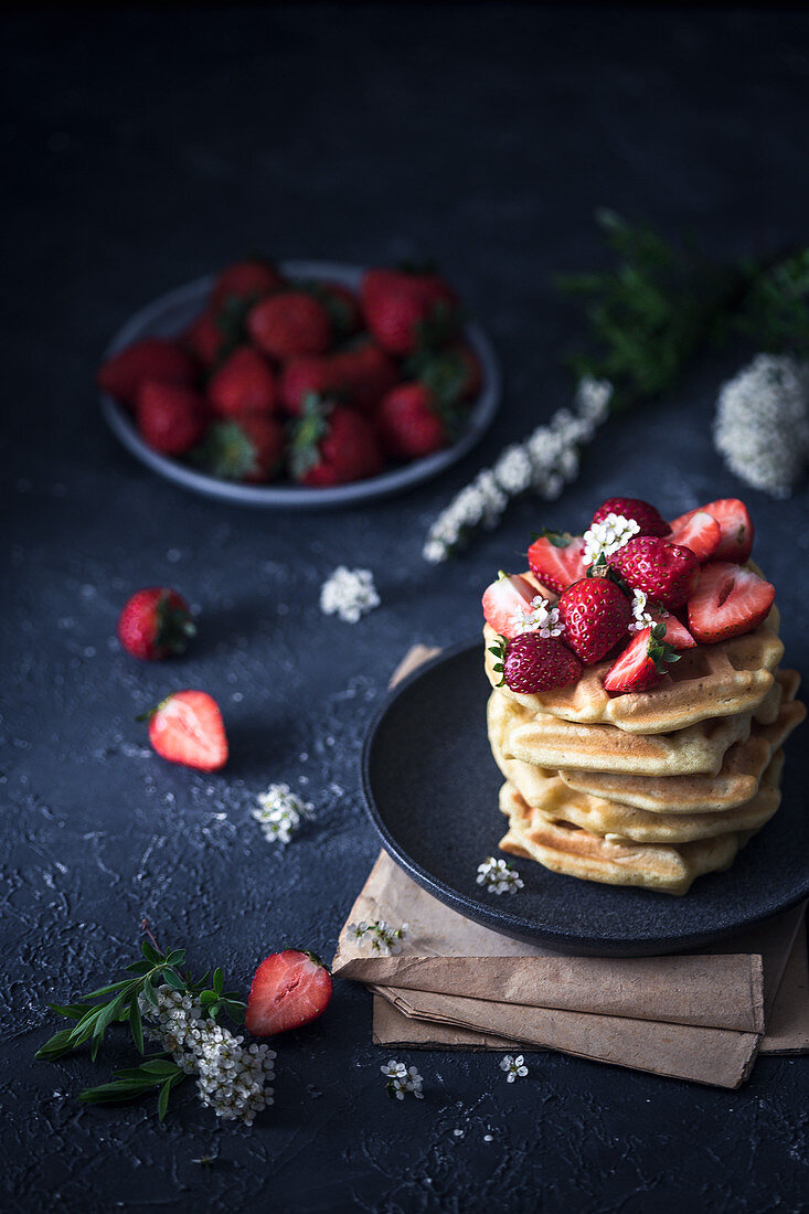 Stack of waffles with fresh strawberries