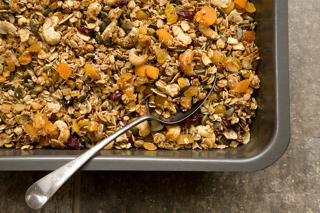 Granola in roasting tin with spoon