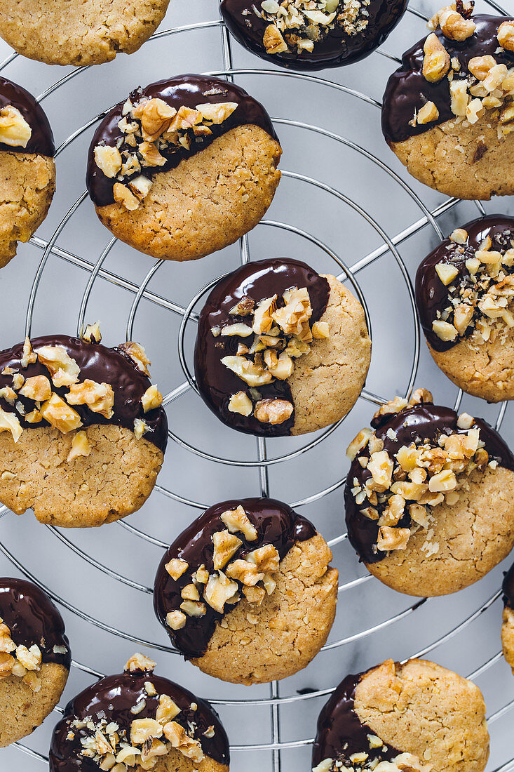 Cookies with walnuts and chocolate placed on metal tray on table in kitchen