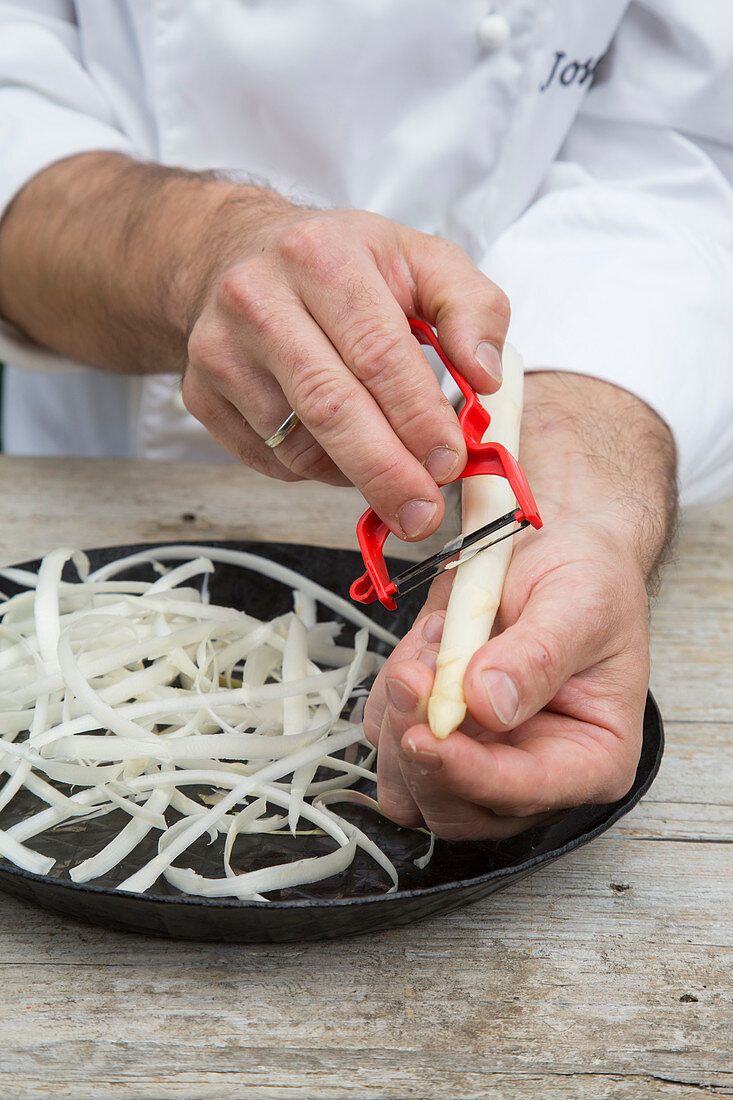 White asparagus being peeled