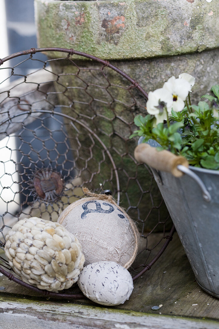 Eggs covered with various materials in wire basket