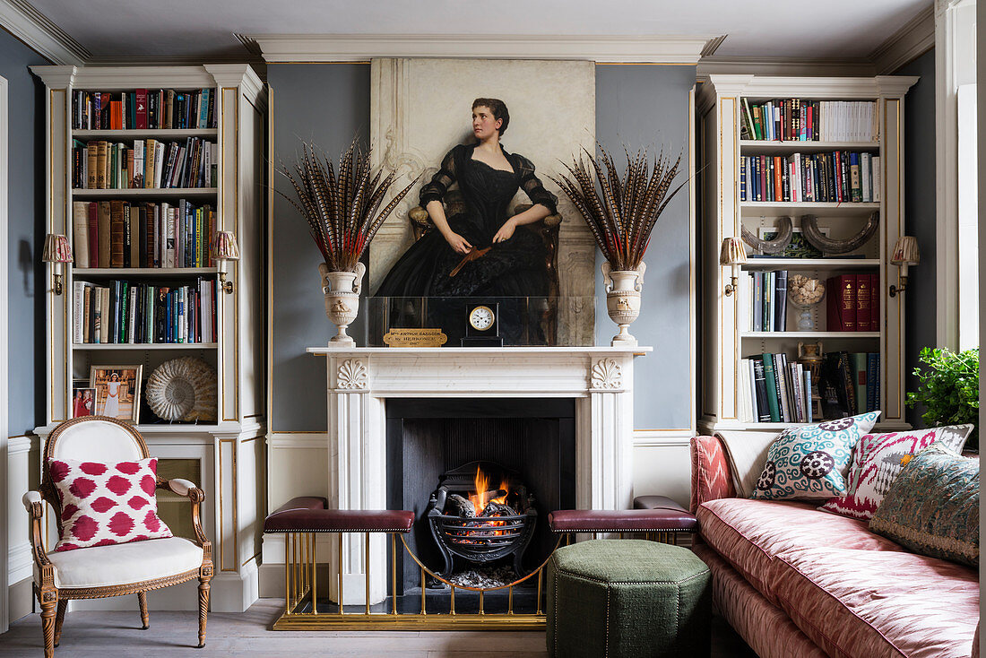 Symmetrical ornaments on mantel of open fireplace in classic living room