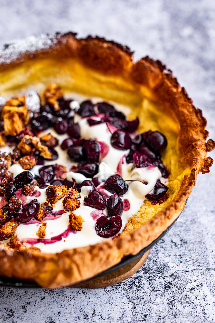 Dutch Baby (Puff Pancake) with Roasted Cherries and Panettone Croutons