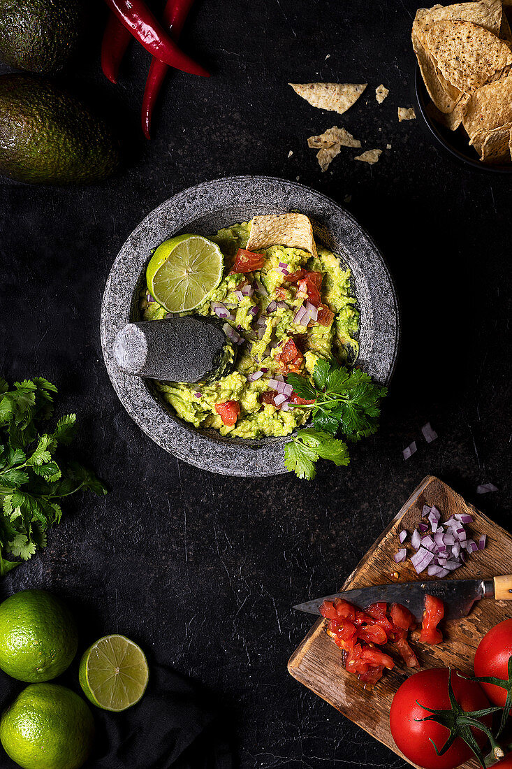 Vegetarian guacamole with tomatoes and lime garnished with fresh parsley