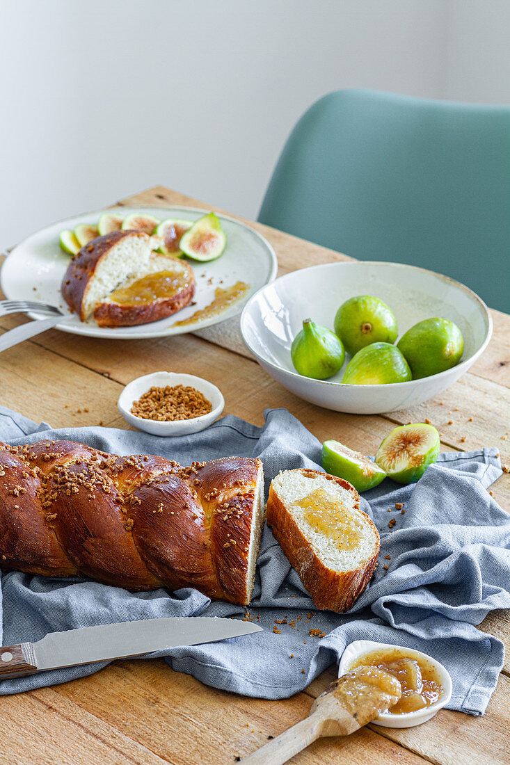 Braided bread served with fresh figs and sweet fruit jam