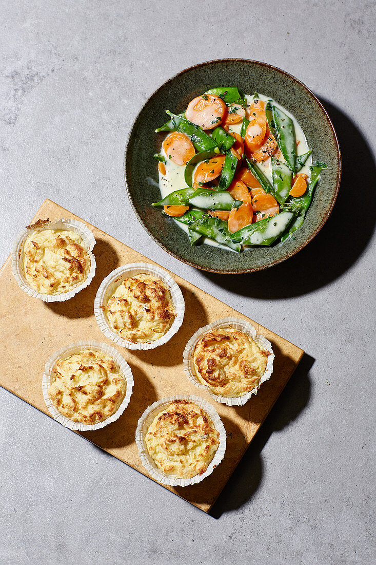 Fish and potato cakes with a carrot and mange tout medley