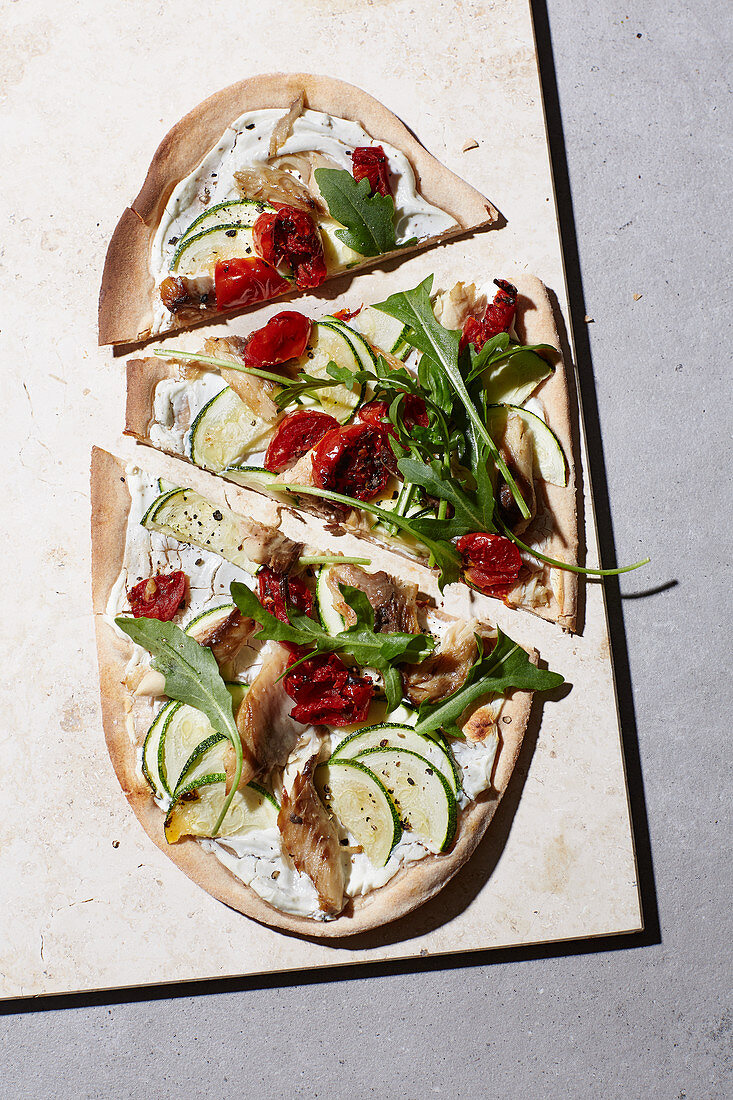 Spelt tarte flambé with mackerel, courgette and goat's cheese