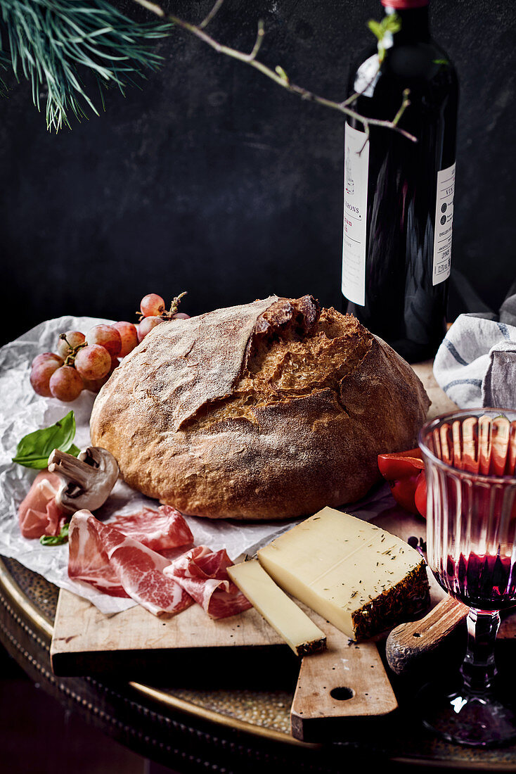 Supper with sourdough bread, Serrano ham, alpine cheese and red wine