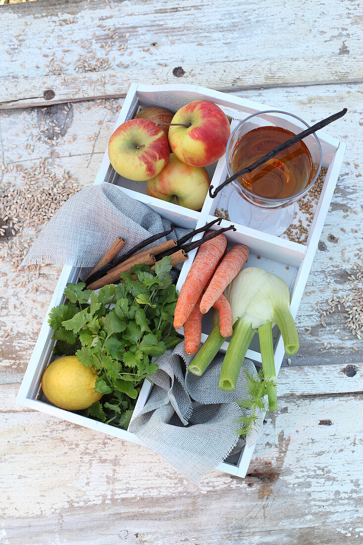 Fruits, vegetables, herbs, spices and agave syrup in a wooden box