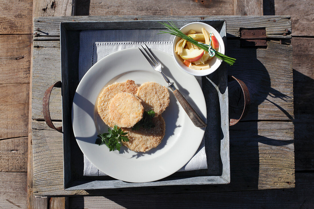 Celery schnitzel with apple and potato salad