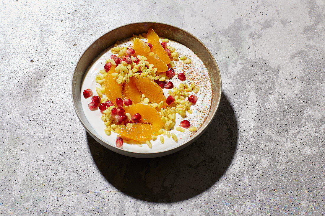 Turmeric bowl with oranges, pomegranate and almond quark