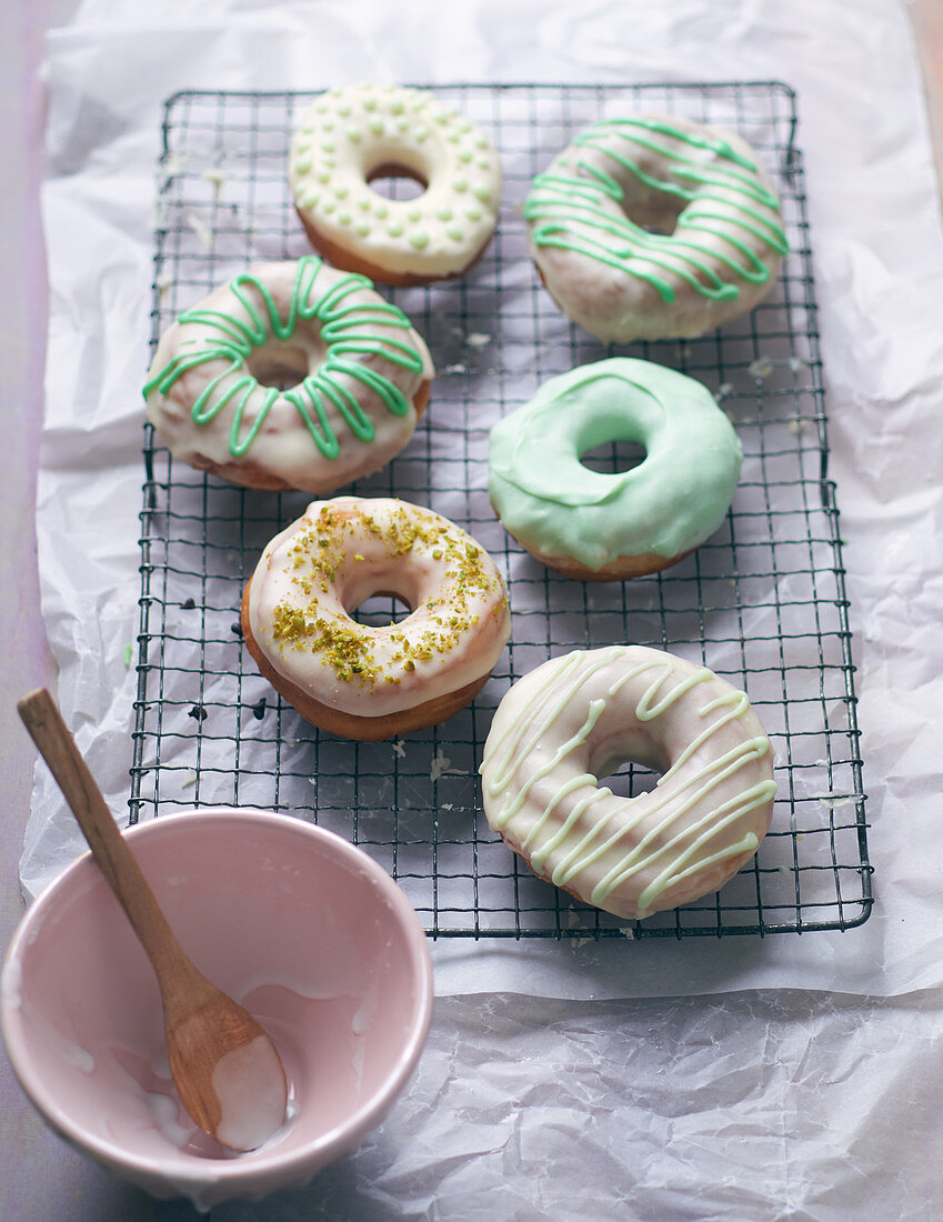 Colourful doughnuts on a wire rack