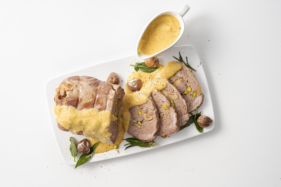 Stuffed pork neck cooked in milk with chestnuts and pistachio nuts