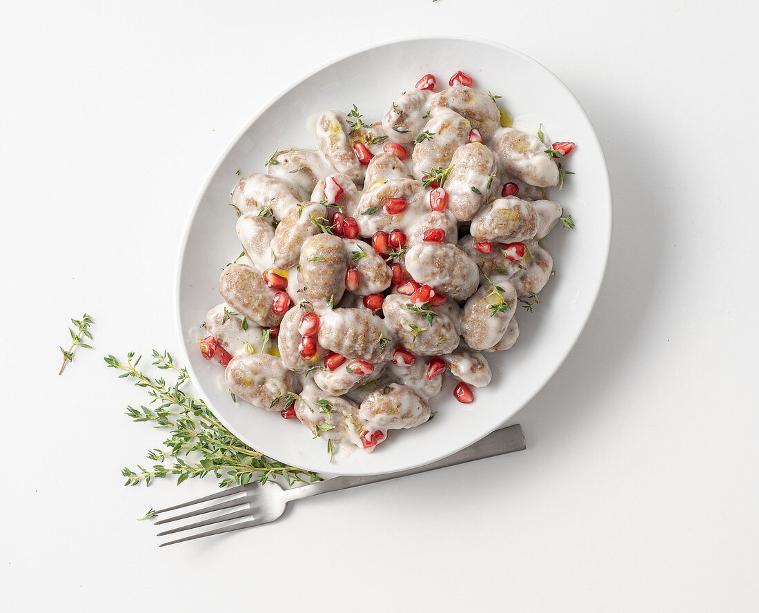 Chestnut gnocchi with Parmesan sauce and pomegranate seeds