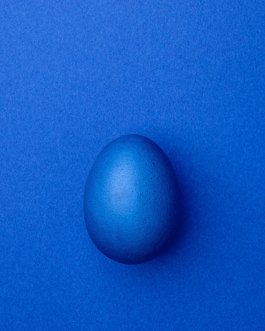 Blue Easter egg on a blue background