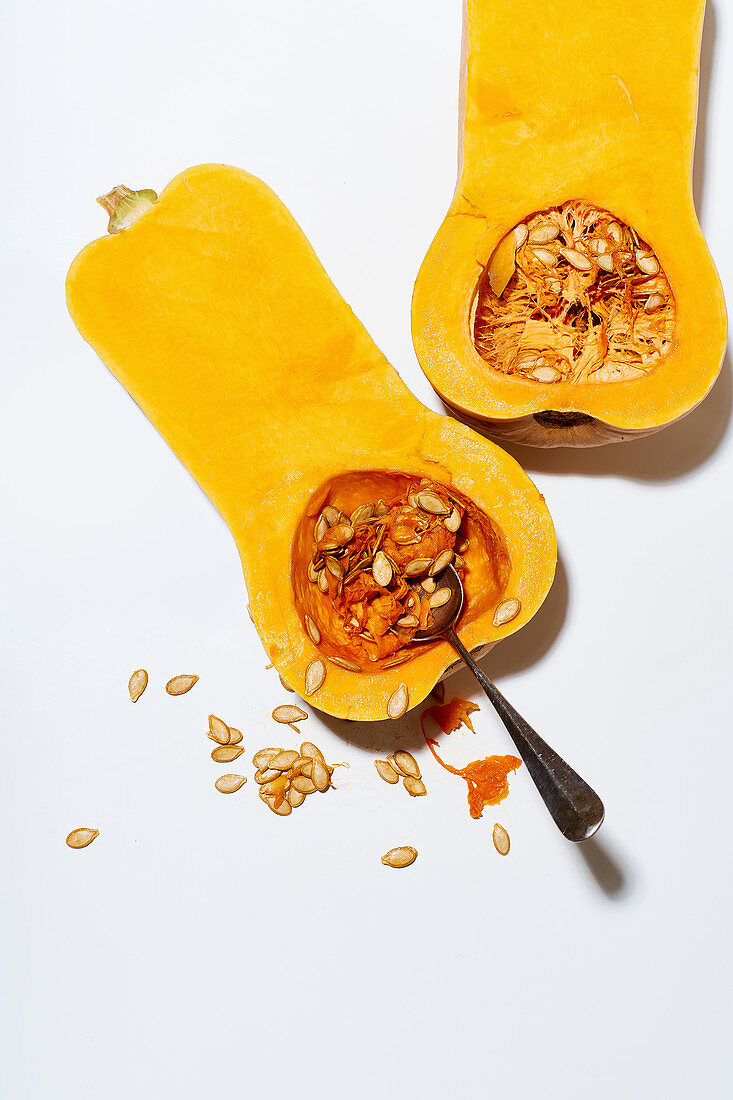 Deseeding a butternut squash with a spoon