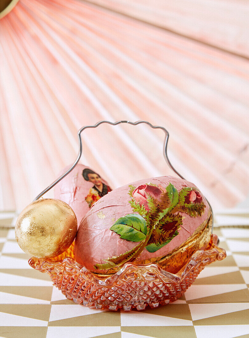 Easter eggs decorated with decoupage technique in glass basket