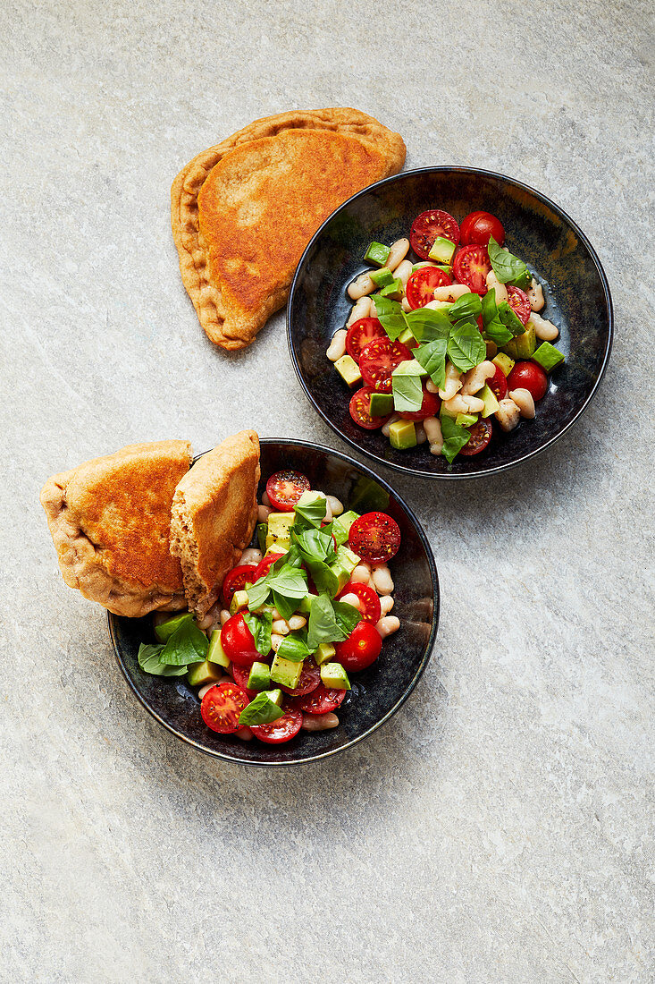 Tomato and bean salad with walnut naan bread served in pans