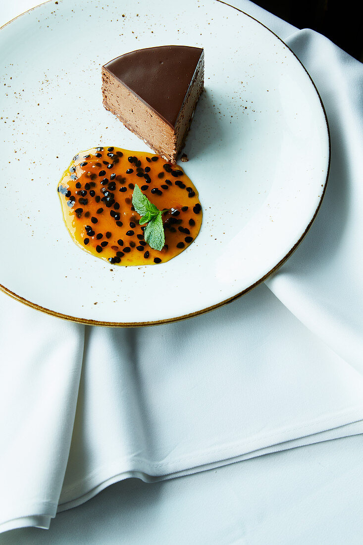 Truffle cake with sugared almonds and passion fruit sauce