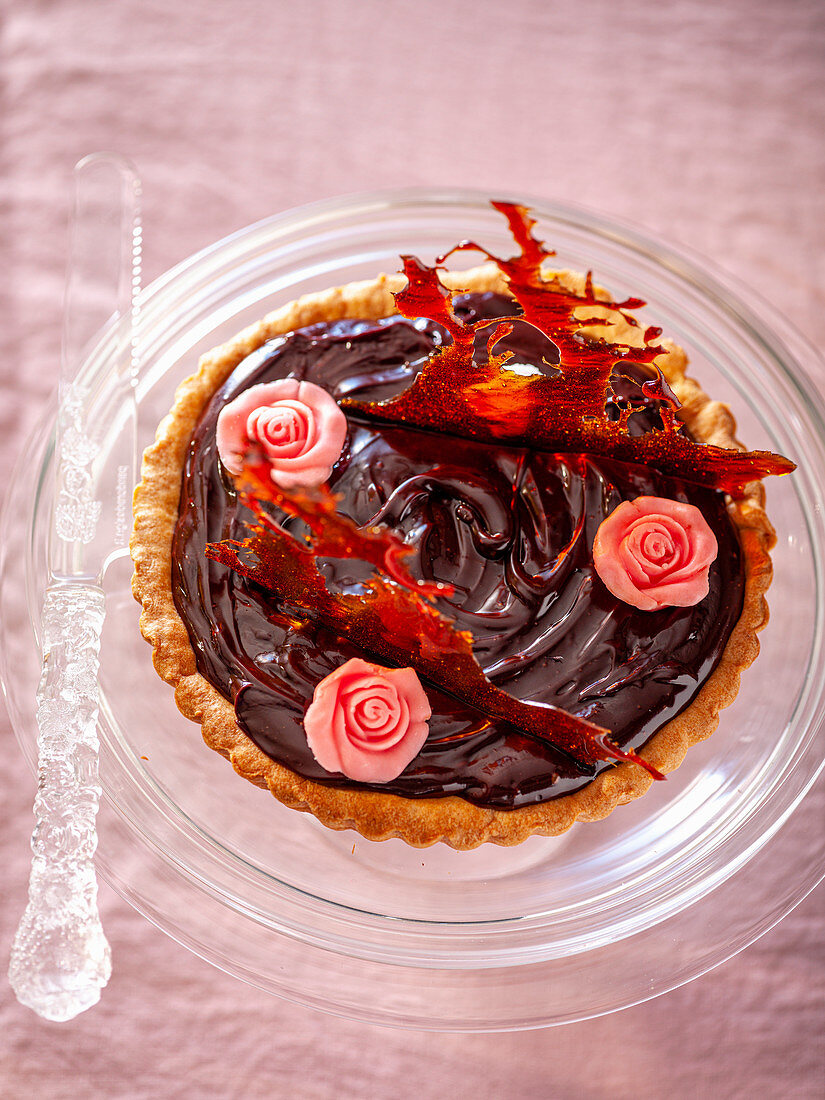 Chocolate tart with caramel and fondant rose petals