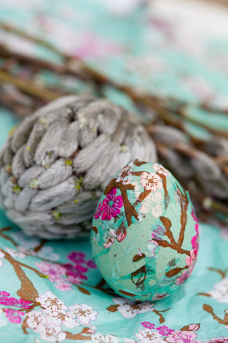 Easter eggs decorated with decoupage wrapping paper and willow catkins