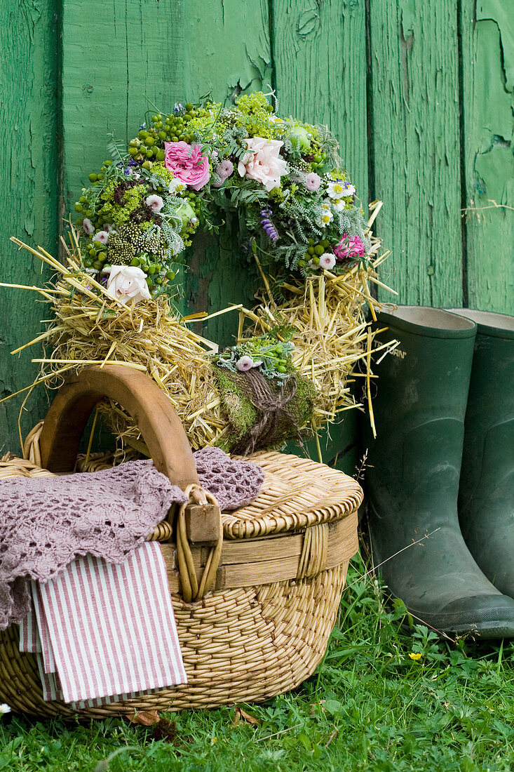 Summer wreath of roses, lady's mantle, chamomile, tufted vetch, green apples and straw