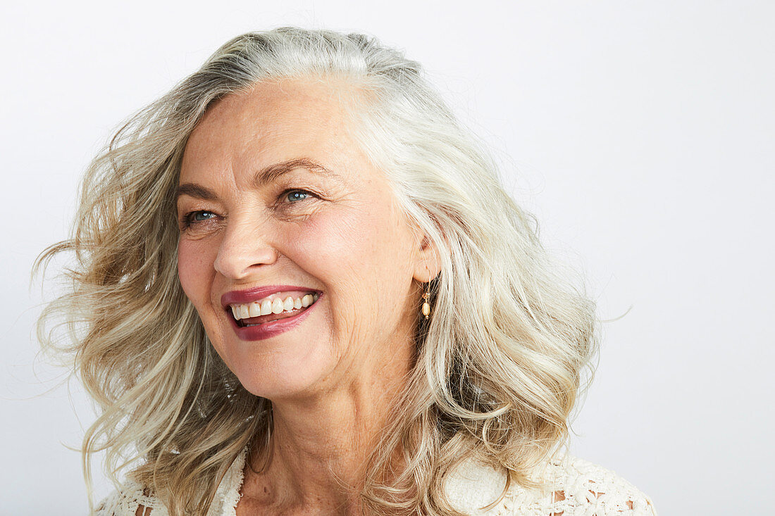A smiling, grey-haired woman