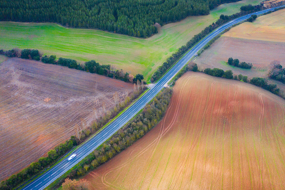 Road through farmland, aerial view