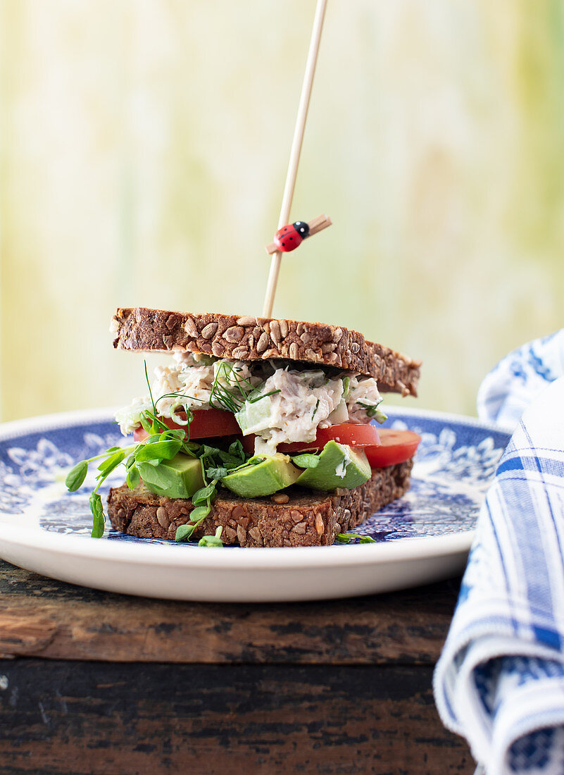 Chicken salad on toast with tomatoes, avocado and mustard