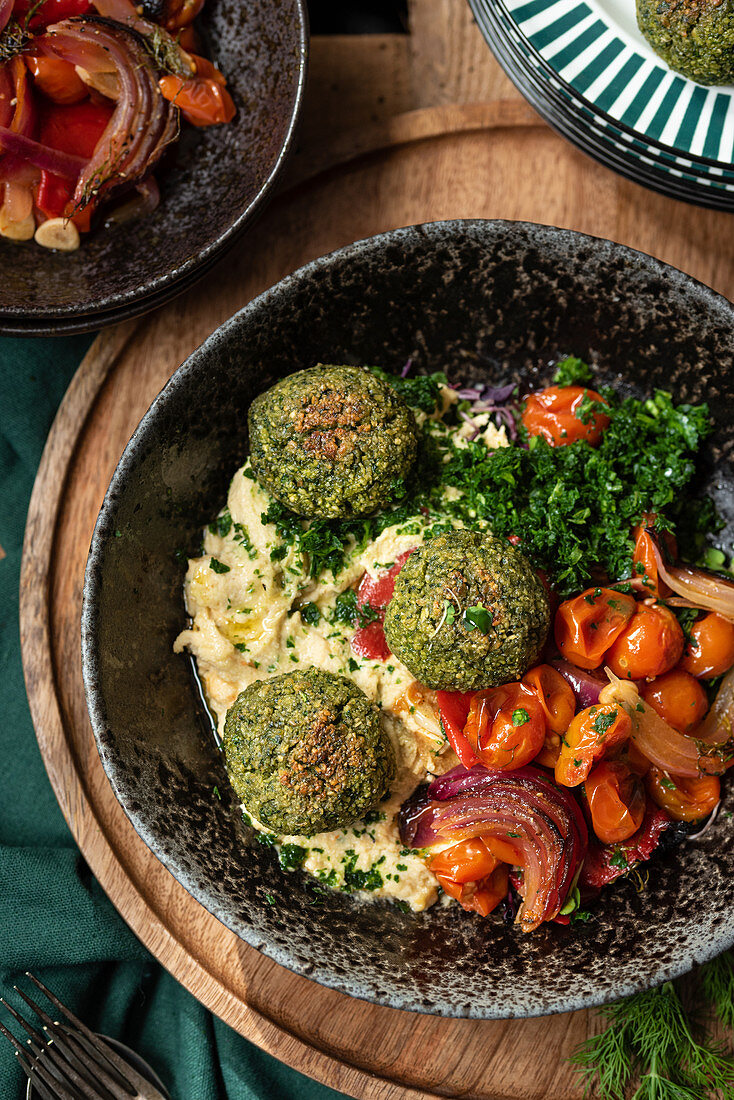 Vegetarian hummus and falafel served with vegetables and green herbs