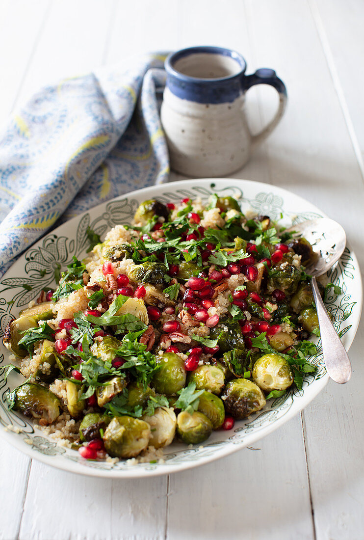 Roasted Brussels sprouts with quinoa, pecan nuts, pomegranate seeds and maple syrup