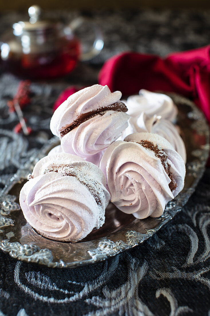 Black currant meringue cookies with whipped chocolate filling