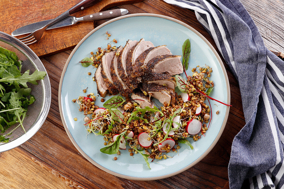 Duck breast served with fried sprouts