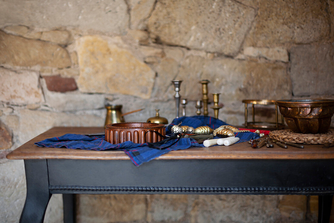 Rustic table still life made with copper baking tins and silverware