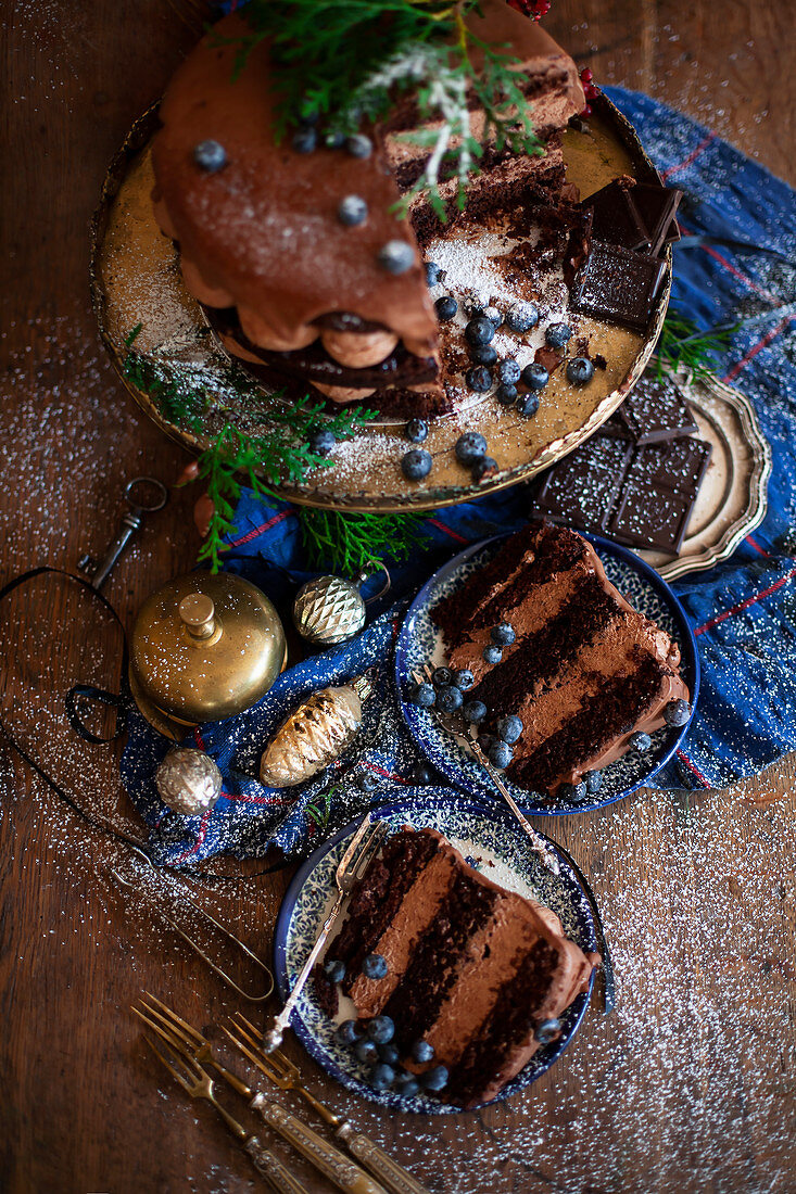 A Christmas chocolate cream cake with ganache and blueberries