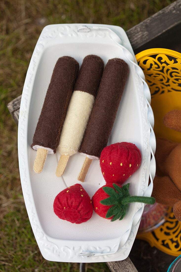 Handmade felt ice-cream and strawberries on tray