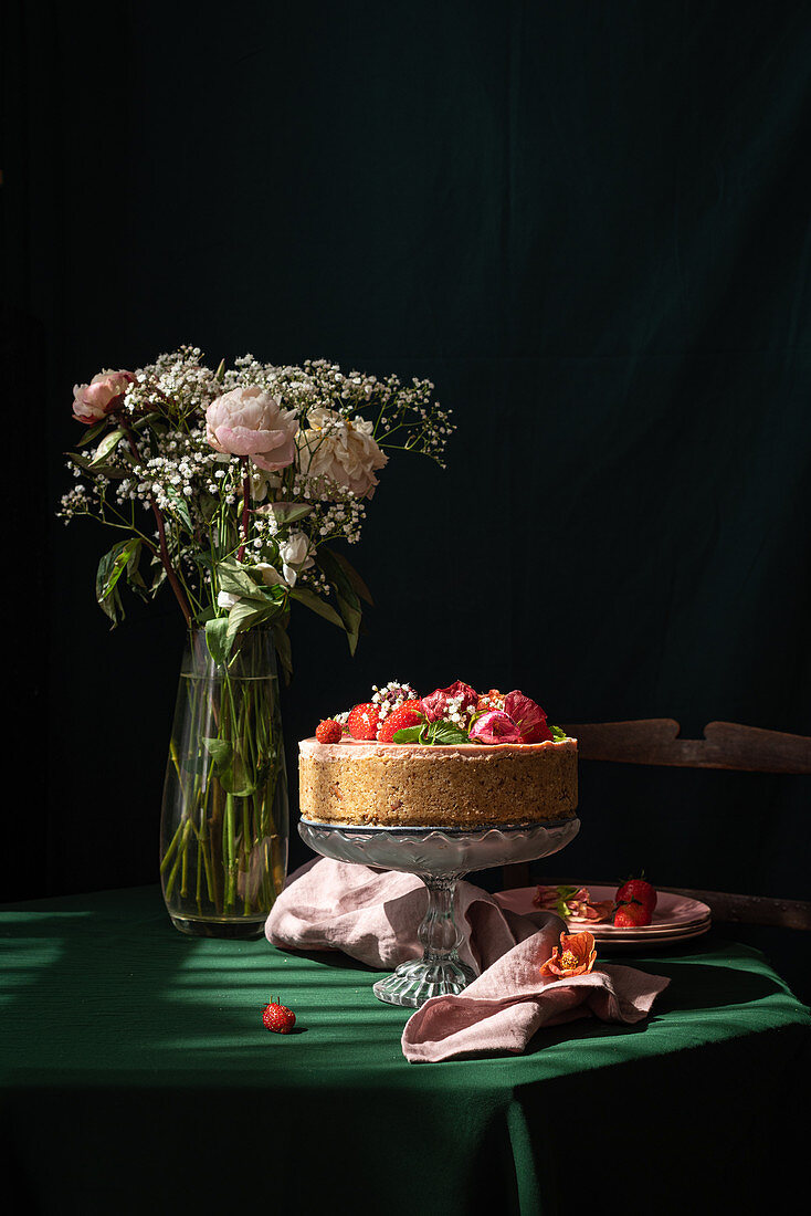 Strawberry cheesecake decorated with fresh berries and flowers