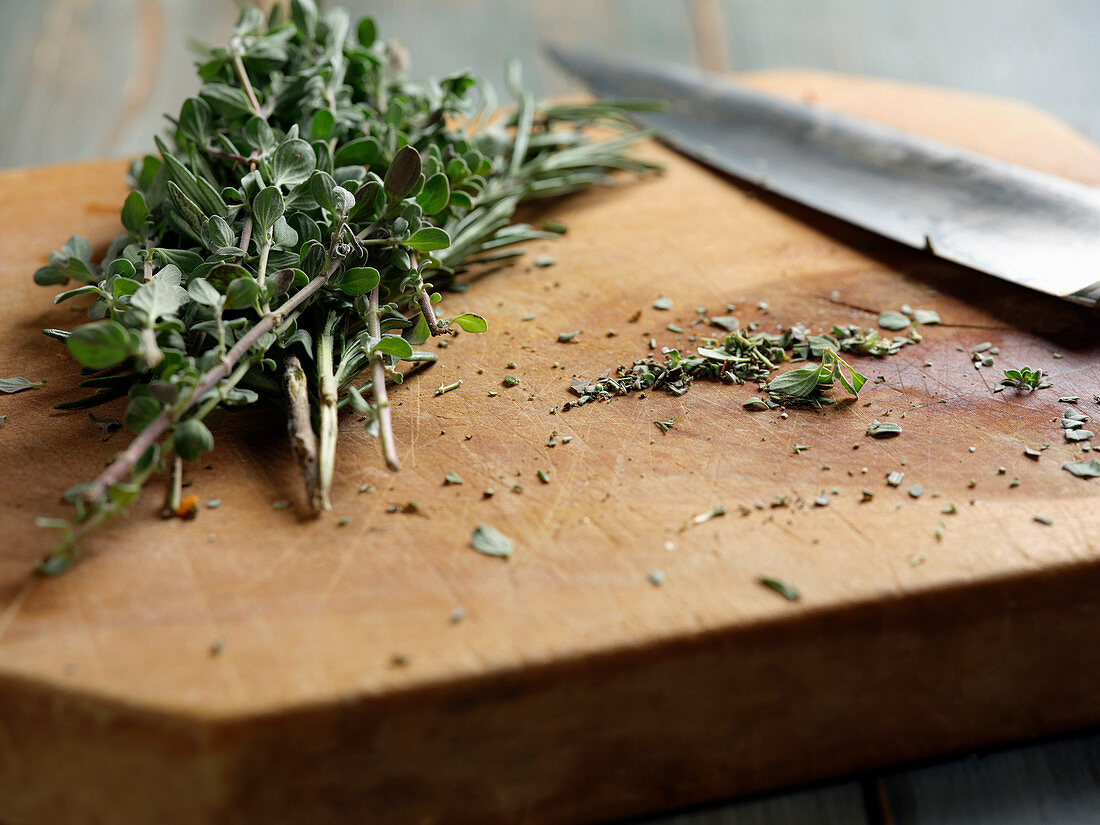 Fresh herbs on wooden chopping board