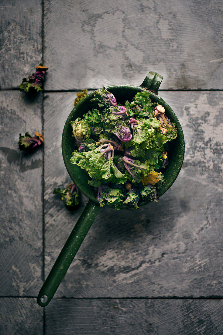 Flower sprouts (a cross between kale and Brussels sprouts) in a vintage sieve