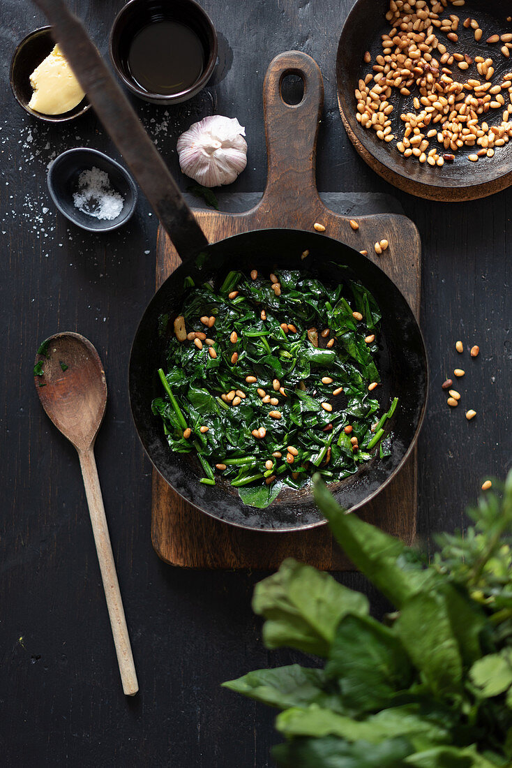 Catalan spinach with pine nuts in frying pan