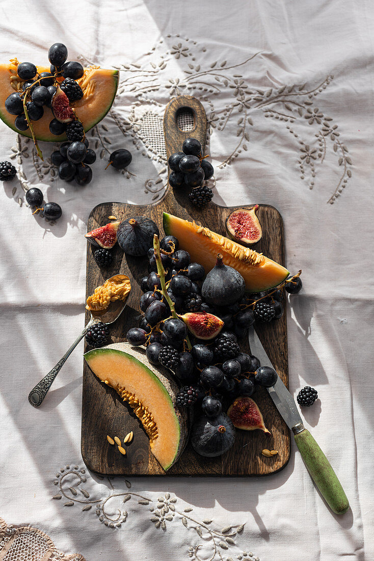 Fruits on old wooden chopping board