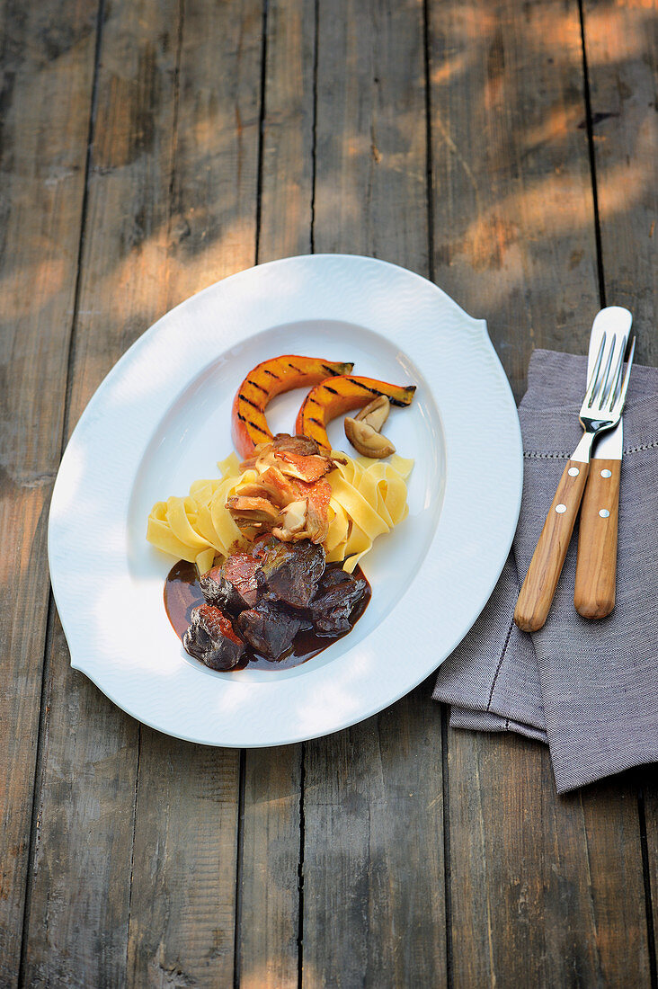 Wild hare stew with grilled pumpkin wedges and tagliatelle